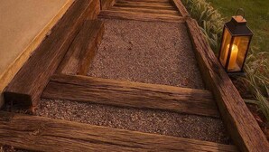 A wooden staircase leading to a house with a view of a sunset. - Compass Retreat for large groups (Buchanan)