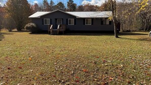 A single-story house with a front porch and a covered driveway.