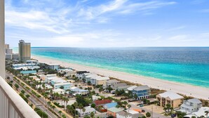 A coastal town with a beach, residential buildings, and a clear view of the ocean.