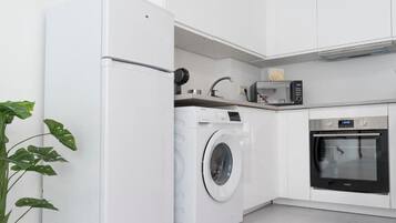 Family Apartment, 4 Bedrooms | Private kitchen | Full-size fridge, microwave, stovetop, cookware/dishes/utensils