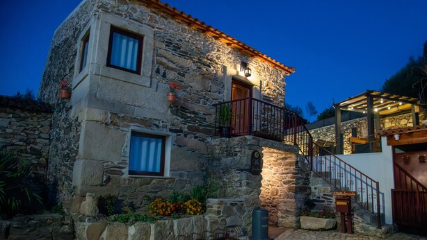 A stone building with a balcony, a staircase, and a wooden door. - Country House 'Villa Jerusalém' with Mountain View, Wi-Fi & Air Conditioning (Romeu)