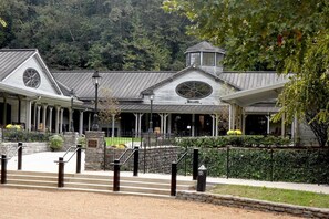 A large building with a covered entrance and a sign that reads "Welcome".