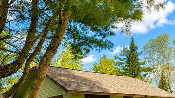 A small, single-story cabin with a sloped roof, a front door, and a small porch area.