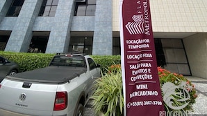 A tall building with a maroon banner advertising relocation services.