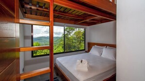 A bedroom with a large window offering a view of a mountainous landscape. - 3-bedroom villa in Platanillo, ocean & mountain view! (Platanillo)