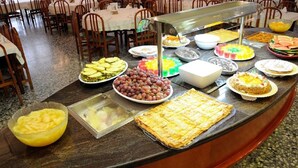 A buffet with various food items including fruits, cakes, and pastries. - Marinada Hotel (Salou)