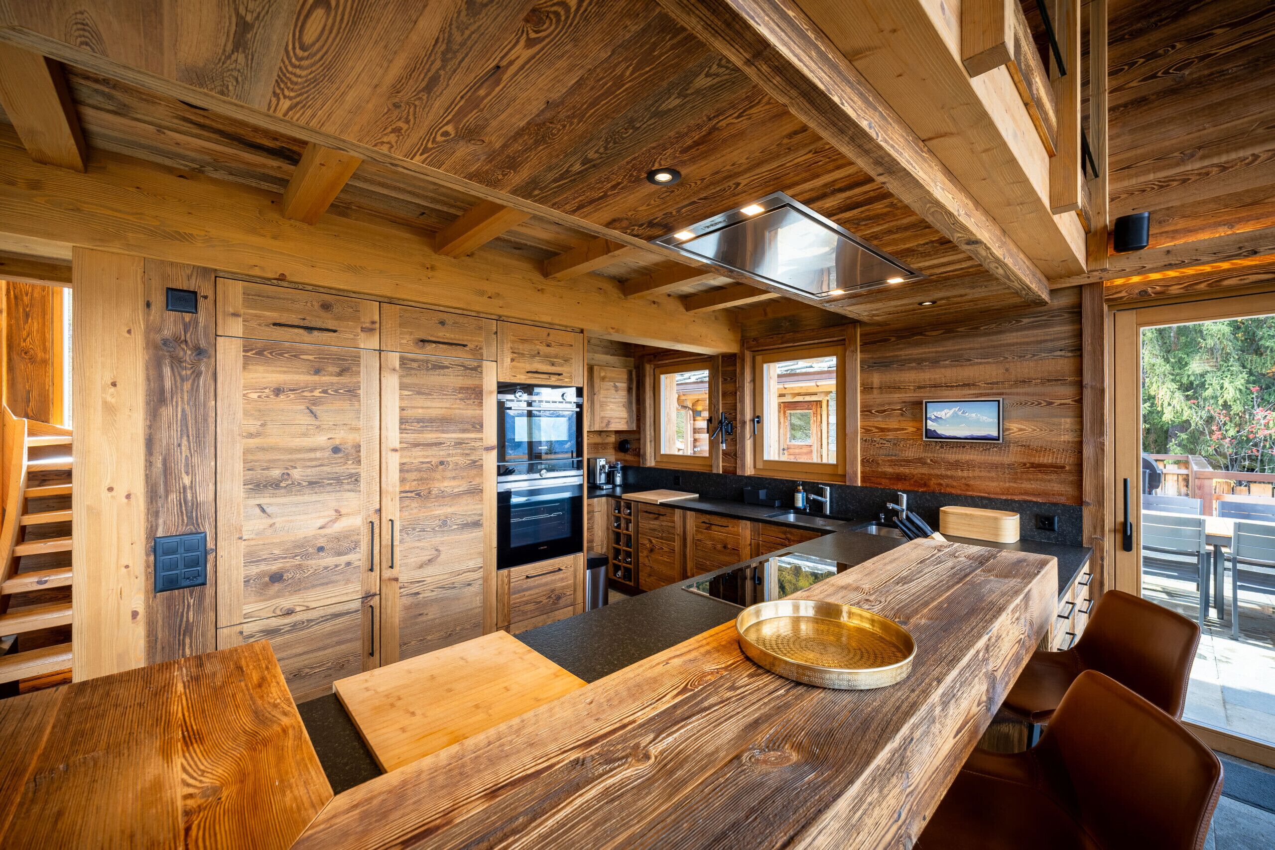 A modern kitchen with wooden cabinetry and a large island.