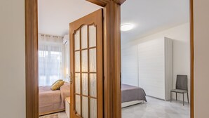 A bedroom with a bed, a chair, and a wardrobe. - Bijoux in the Centre of Sanremo by Wonderful Italy (Sanremo)