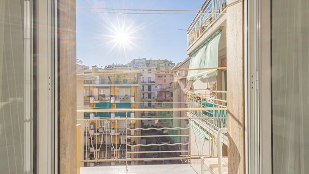 A balcony with a view of a cityscape, featuring buildings with balconies and a clear sky. - Bijoux in the Centre of Sanremo by Wonderful Italy (Sanremo)
