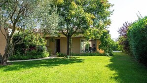 A house with a well-maintained lawn, a patio with outdoor furniture, and a garden with various plants and trees. - La Bienvenue - Four Bedroom Villa, Sleeps 8 (Pézenas)