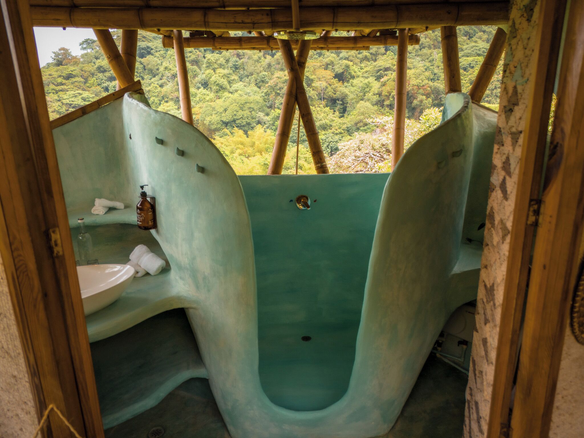 A bathroom with a unique design, featuring a large bathtub and a sink.