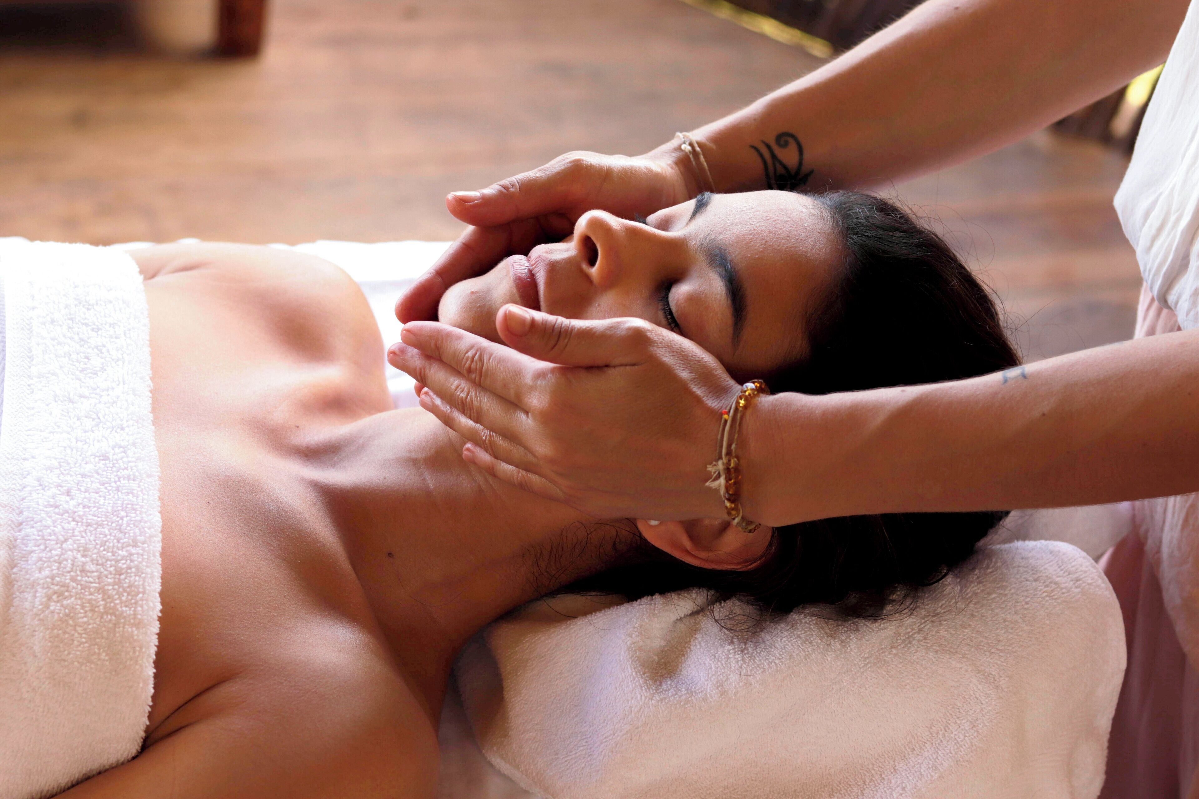 A person receiving a facial massage.