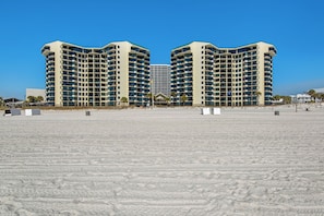 A large hotel with a symmetrical facade, multiple balconies, and a central entrance. - ⭐Gulf and Pool Views-1BR-Pool-Sunbird 212E⭐ (Panama City Beach)
