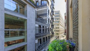 A multi-story building with balconies, large windows, and a narrow alleyway. - Cerva - Stylish 1 Bedroom Close to Duomo (Milan)