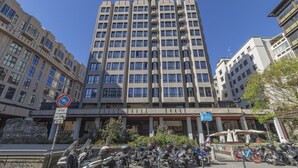 A multi-story building with a modern architectural design, featuring a series of balconies and large windows. - Central Tower S Babila - Elegant 2bdr With Rooftop Terrace (Milan)