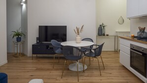 A modern kitchen with white cabinets, a wooden countertop, and a built-in oven. - Porta Vittoria - Cozy Stylish 1bdr in Duomo San Babila Area (Milan)