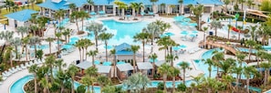 A resort with multiple swimming pools, palm trees, and lounge areas. - Stylish Vacation Home w Pool Game Room Resort Fun (Davenport)