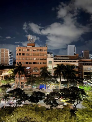 A multi-story building with a brick facade, large windows, and a flat roof. - Hotel Plaza Mayor 44 - Medellin (Medellín)