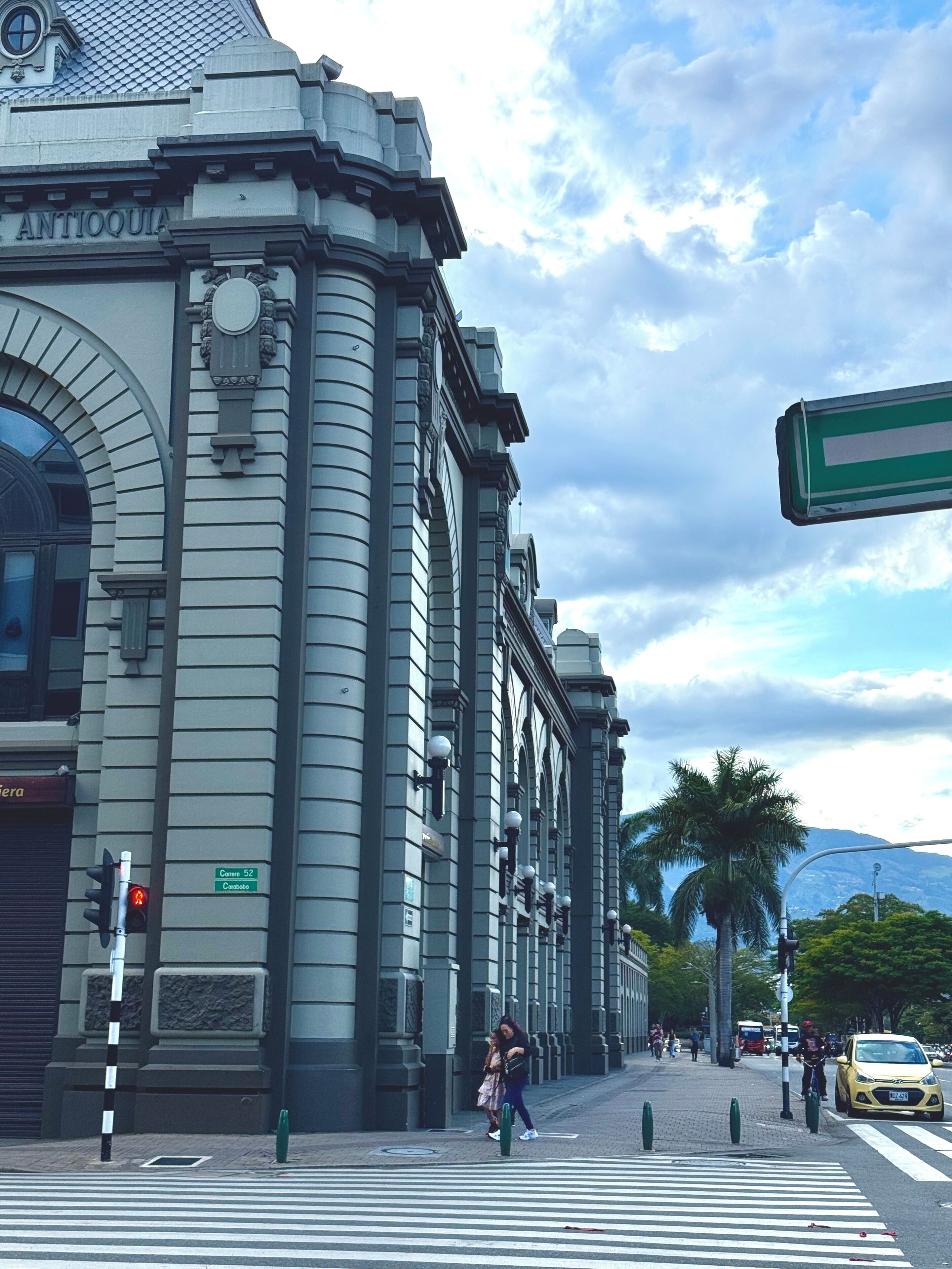 A historic building with classical architecture, including a prominent arched entrance and detailed stonework.