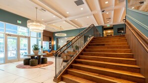 A staircase with wooden steps and metal railings leading to an upper floor. - 1BR | Gym, Views | Bellevue | Sophari Parkside C (Bellevue)