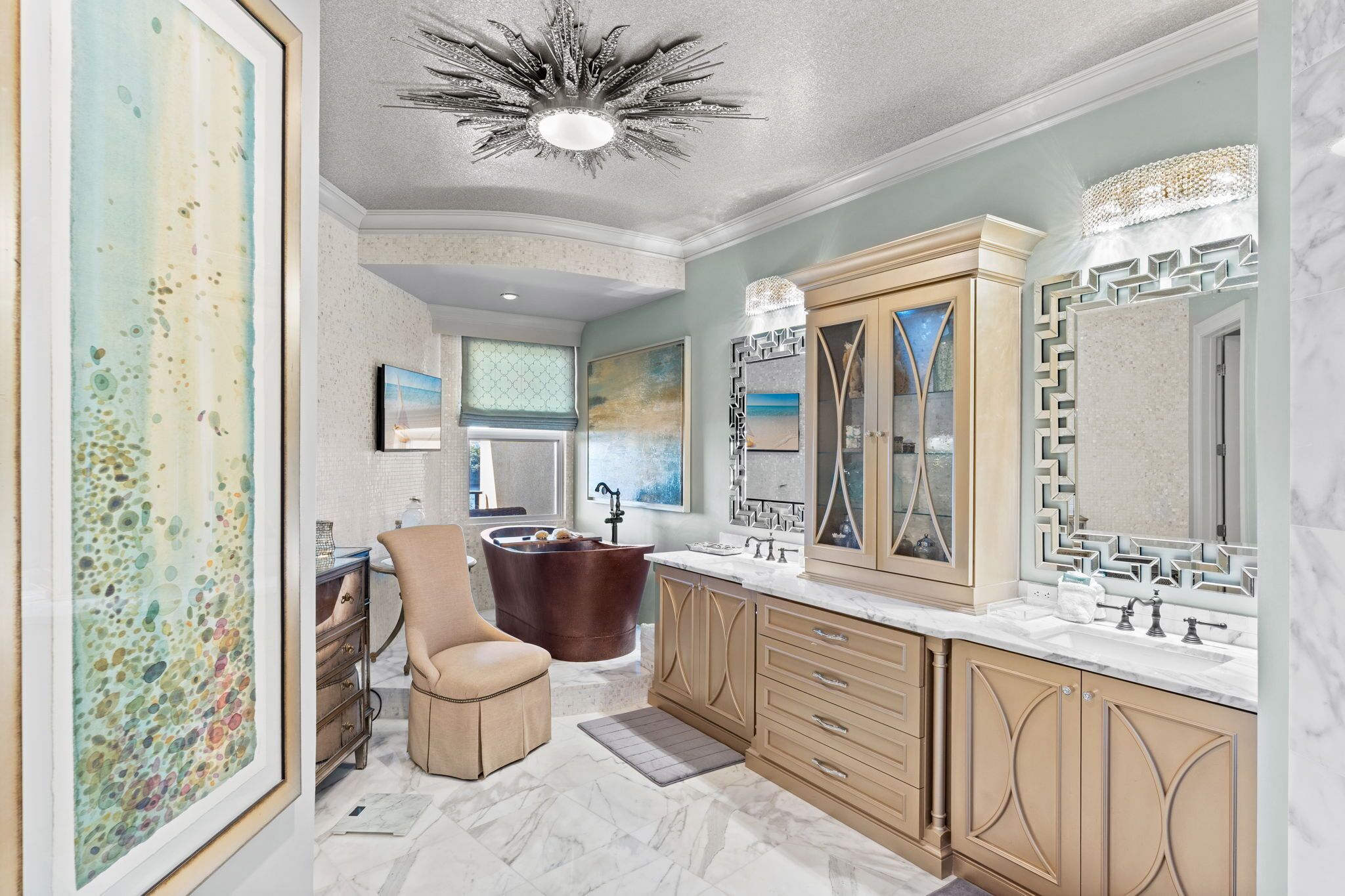 A spacious bathroom with a freestanding bathtub, a large vanity with a mirror, and a ceiling light fixture.
