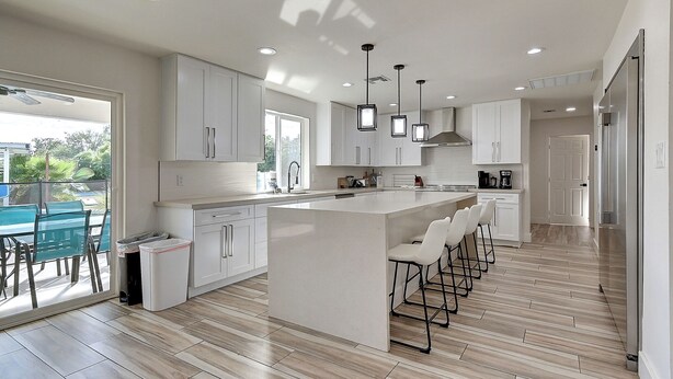 A modern kitchen with a central island, pendant lights, and a view to the outside. - Scottsdalestays Multimillion Estate on Huge Acre Lot-Pool-Slide-Sports Courts (Scottsdale)