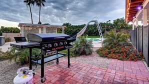 A barbecue grill with a gas tank, a laptop, and a ladder. - Scottsdalestays Multimillion Estate on Huge Acre Lot-Pool-Slide-Sports Courts (Scottsdale)