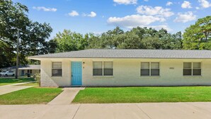 A single-story building with a blue door, numbered 4353, and a small front yard. - Stylish North Charleston Stay | Comfort + Convenience (North Charleston)