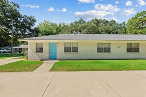 A single-story building with a blue door, numbered 4353, and a small front yard. - Stylish North Charleston Stay | Comfort + Convenience (North Charleston)