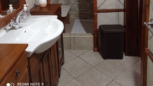 A bathroom with a shower, a sink, and a toilet.