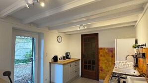 Una cocina con encimera de madera, un lavabo, una estufa y una ventana.