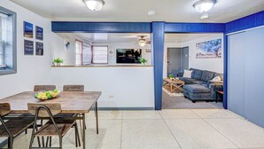 A compact living space with a dining area, kitchen, and seating area. - King Bed Studio | 60" HDTV | Safe | Close to Metra (Elmwood Park)