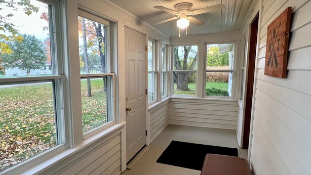 A narrow hallway with white walls and large windows. - Quaint Small Town Home - Country Style Living in Independence (Independence)