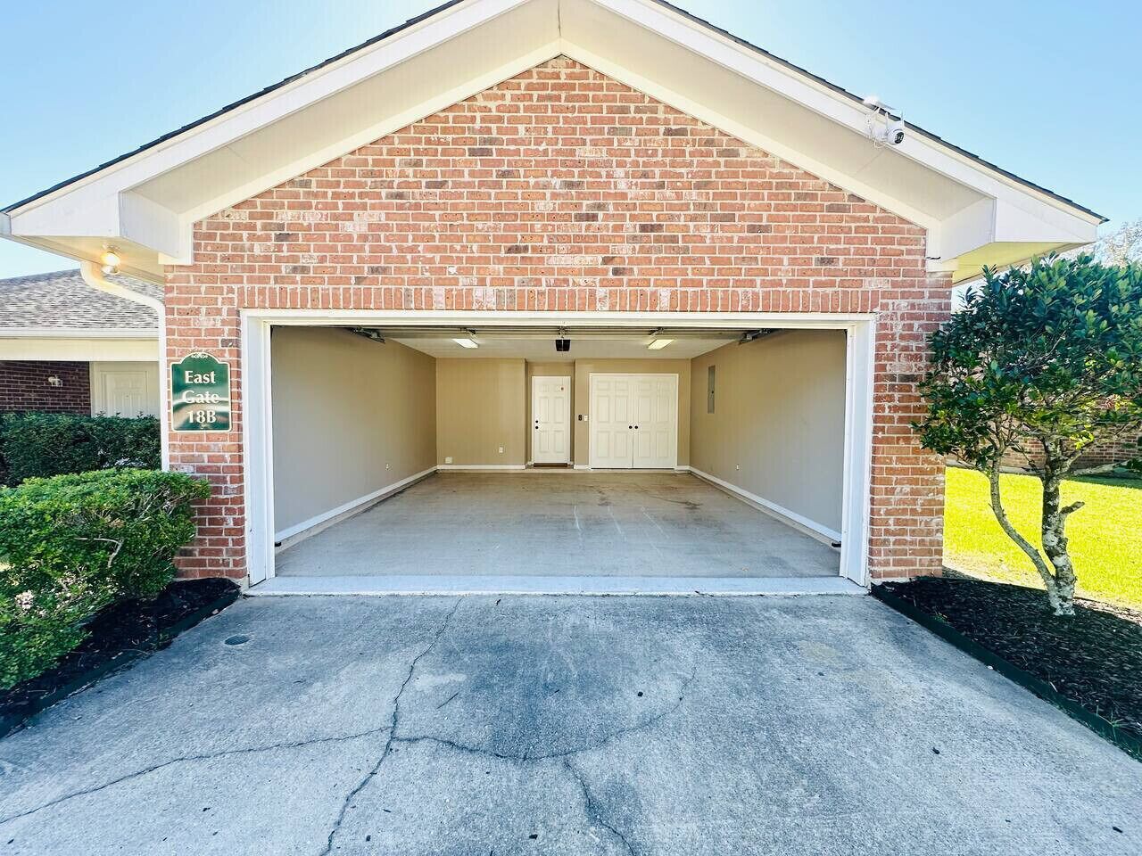 A two-car garage with a brick facade and a flat roof.