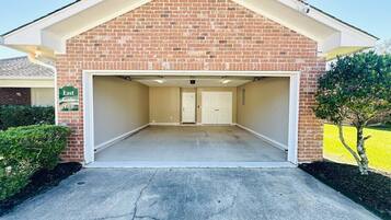 A two-car garage with a brick facade and a flat roof.