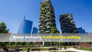Um edifício moderno com varandas e um céu azul límpido.
