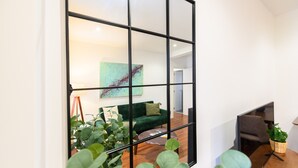 A modern living room with a green sofa, a coffee table, and a plant. - Modern 2-bedroom flat with terrace and fully equipped kitchen_ Madrid . MAL71A (Madrid)
