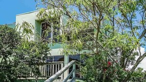 A two-story house with a visible staircase leading to the entrance. - 2BR Stay w/ Bay Views | Near Beach + Pool & Dock (Corpus Christi)