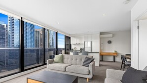 A modern apartment with a large balcony, a dining area, and a kitchen. - Pristine 2-Bed Unit With Beautiful City Landscape (Southbank)