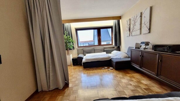 Une chambre d’hôtel avec un lit, un bureau, une fenêtre et une vue sur l’extérieur.