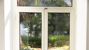 A double glass door leading to an outdoor stone wall and garden. - la terrazza (Tivoli)