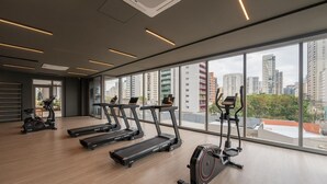 Ett modernt gym med löpband, motionscyklar och en roddmaskin.