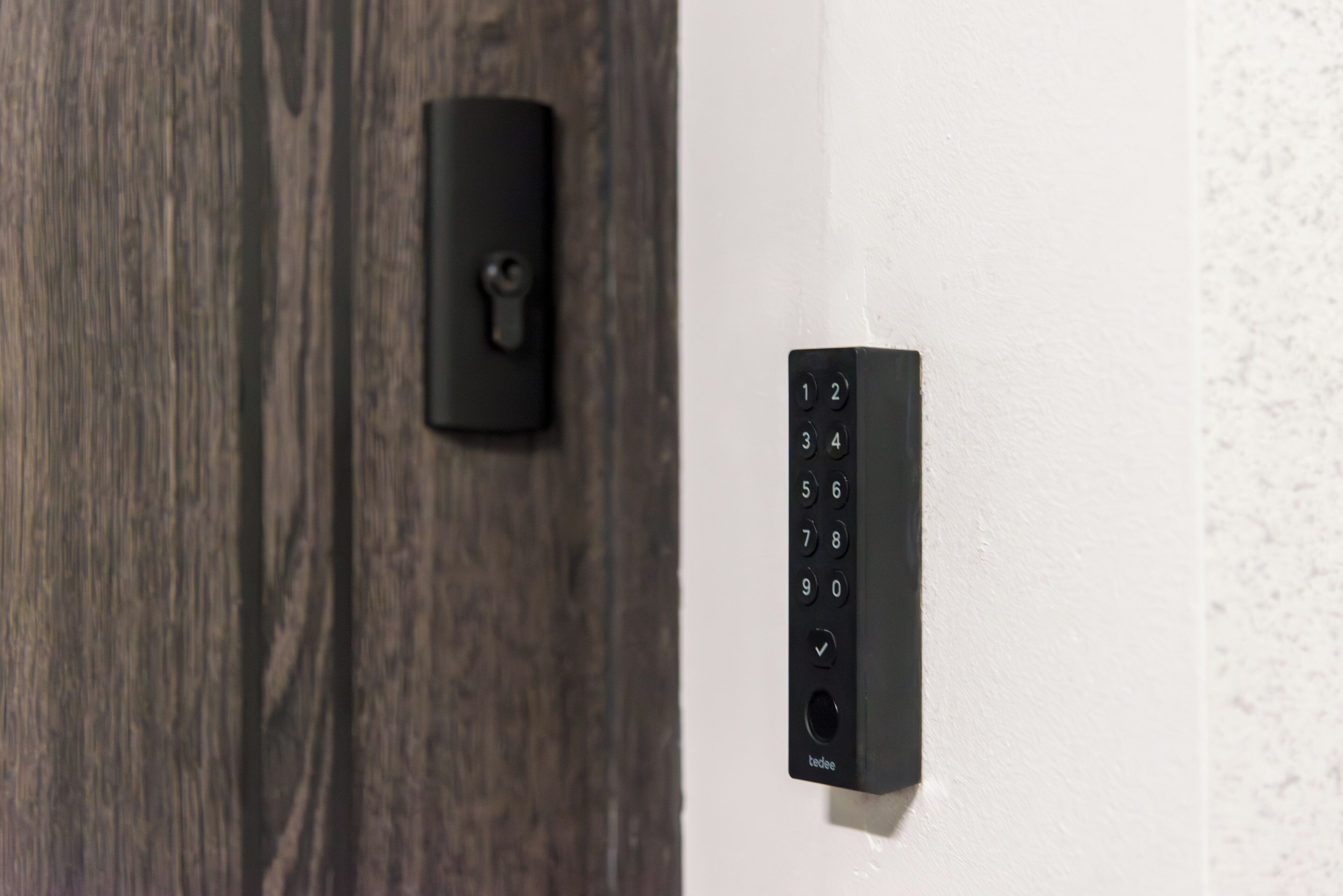 A door with a key lock and a keypad entry system.