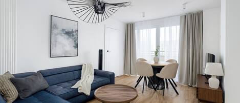 Deluxe Apartment, City View | Living area | 50-inch Smart TV with cable channels, offices