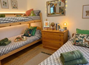 A bunk bed room with a dresser, a mirror, and a small table with a lamp. - Charming Farmhouse Retreat in Santa Ursula, Tenerife (Santa Ursula)