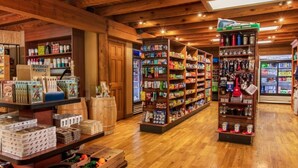 A store with wooden floors and shelves stocked with various products. - DEC 27-Jan 3   89 per ngt.  COZY KING STUDIO! Enjoy Christmas Shows  in Branson (Branson)