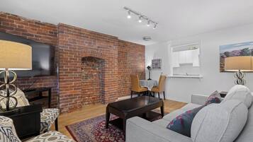 Appartement Confort | Coin séjour | TV connectée de 42 pouces avec chaßnes numériques, Netflix, livres