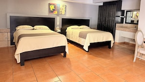 A hotel room with two beds, a small bedside table with a phone, a bathroom with a sink and mirror, and a decorative wall piece above the beds. - Hotel Mirage Express (Matamoros)