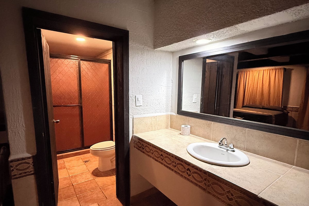 Separate tub and shower, towels, soap, shampoo