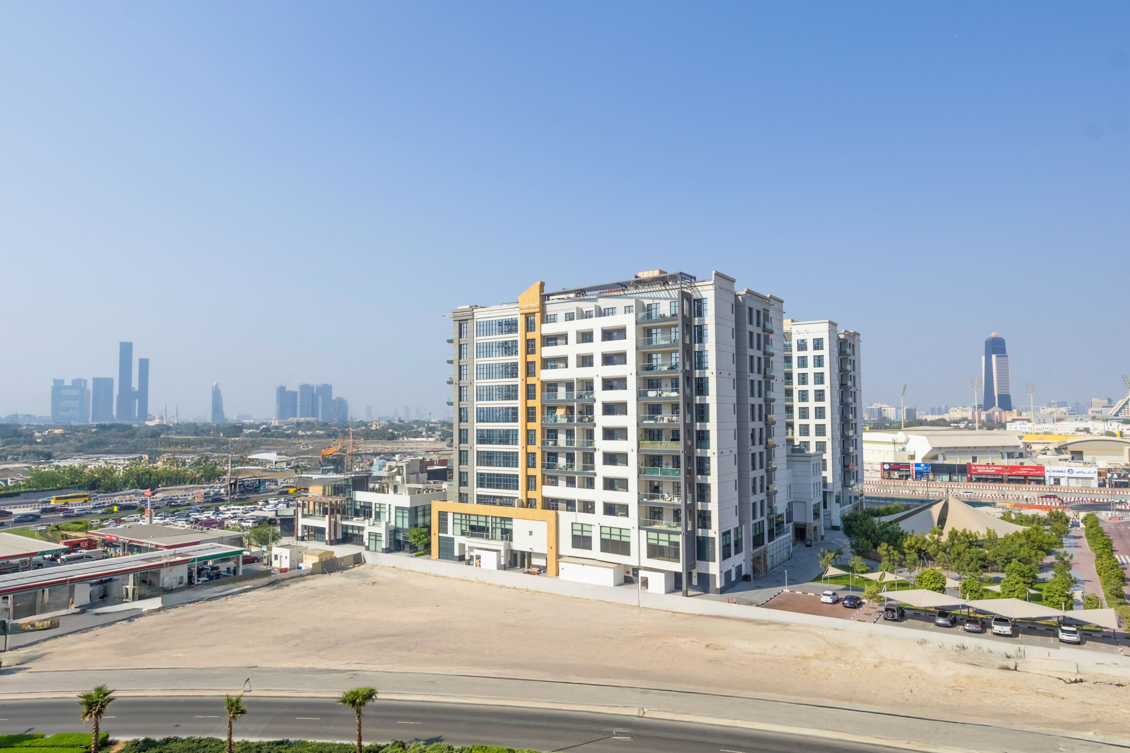 A multi-story building with a modern architectural design, featuring balconies and large windows.